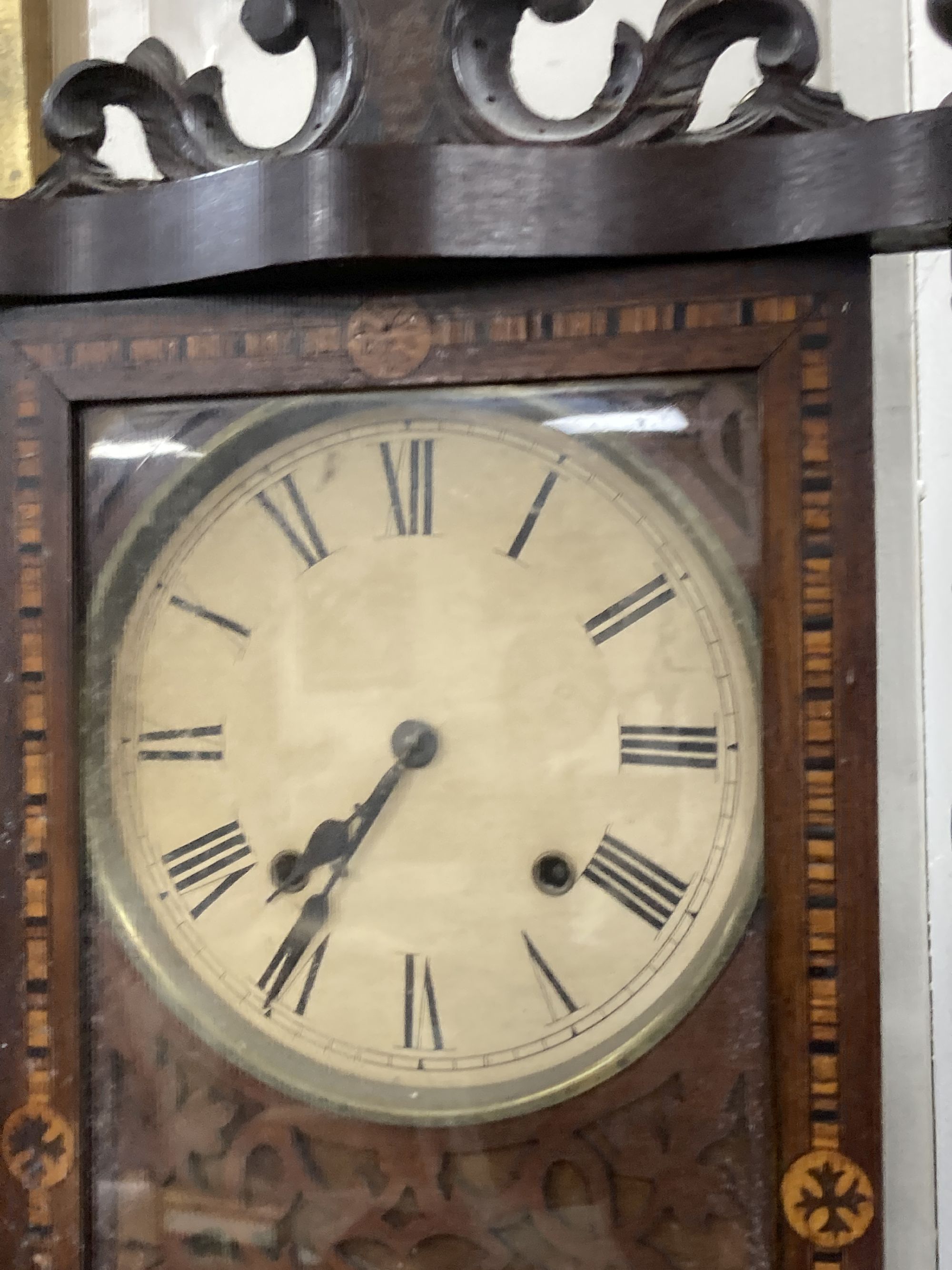 A 19th century American simulated rosewood wall clock, height 84cm, a 19th century inlaid wall clock and a mahogany pedestal cupboard